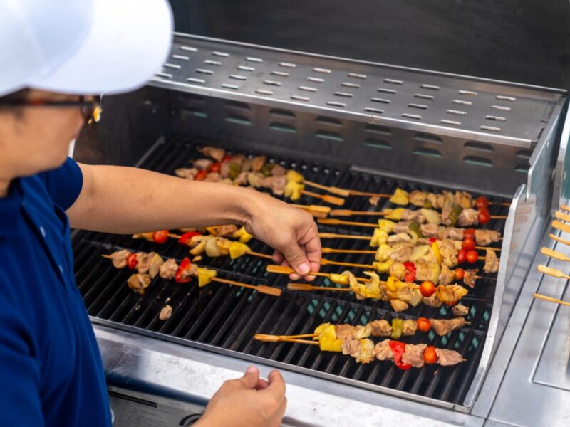 Asian,Man,Chef,Cooking,Grilled,Barbecue,And,Seafood,On,Stove
