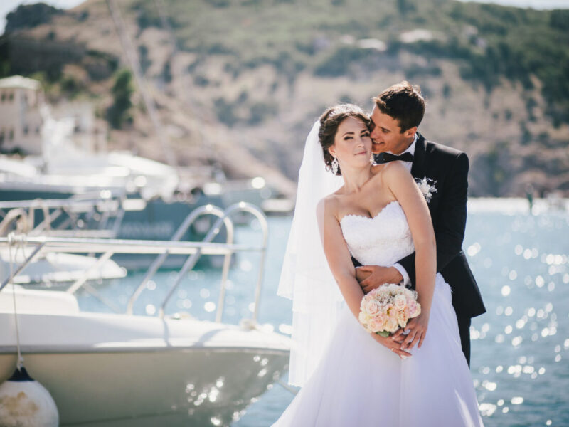 Just,Married,Couple,Posing,In,Small,Cove.,Happy,Bride,And